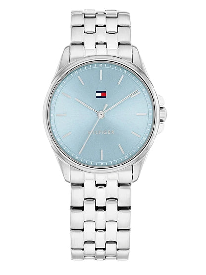 Esfera azul claro del reloj Tommy Hilfiger para mujer con índices horarios y logo de la marca" title: